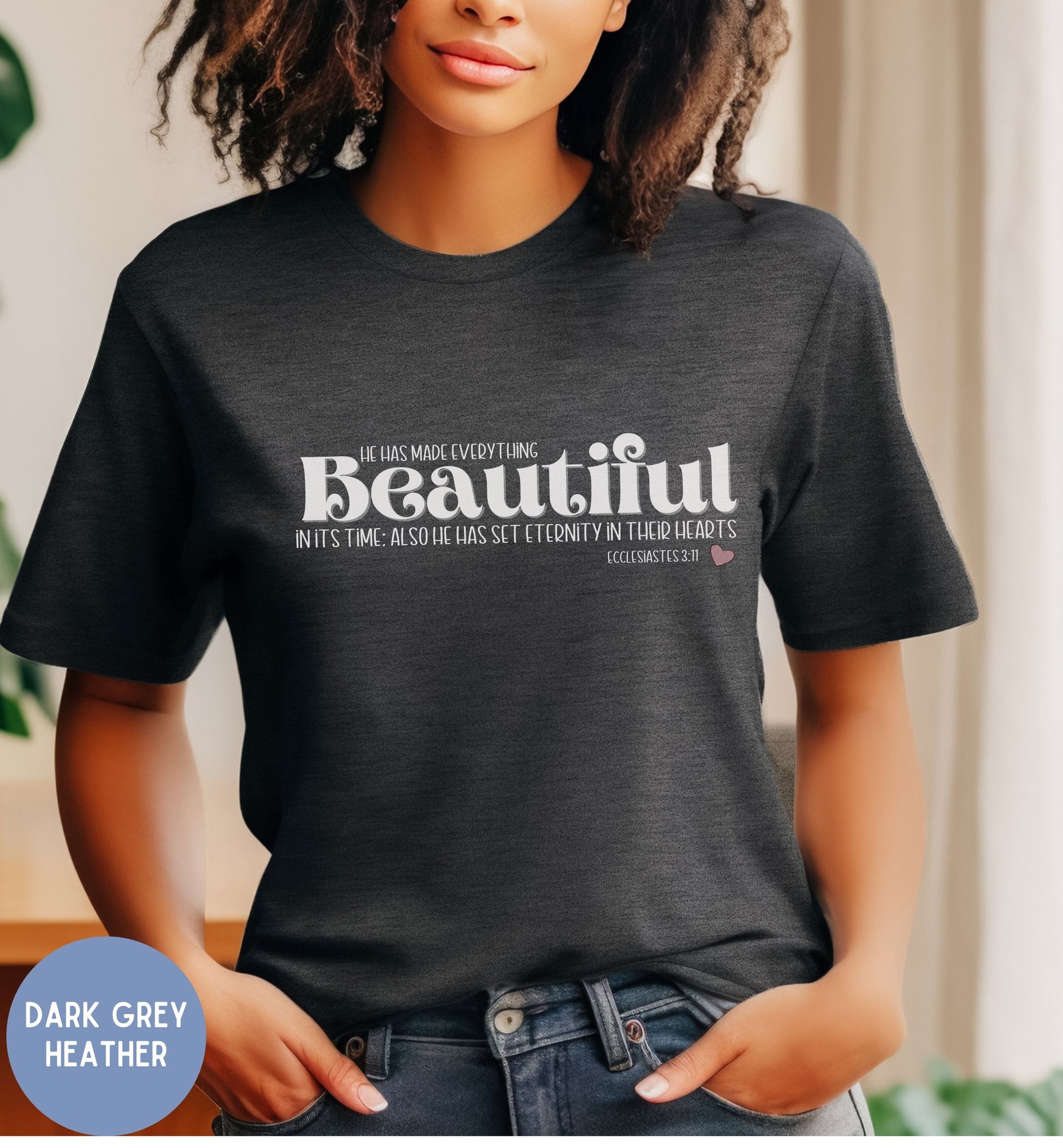 a woman wearing a black t - shirt with the words beautiful on it