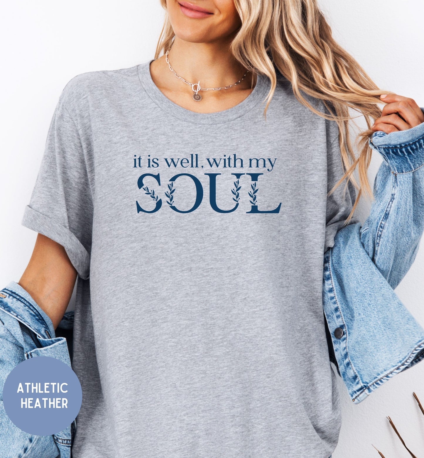 a woman wearing a t - shirt that says it is well with my soul