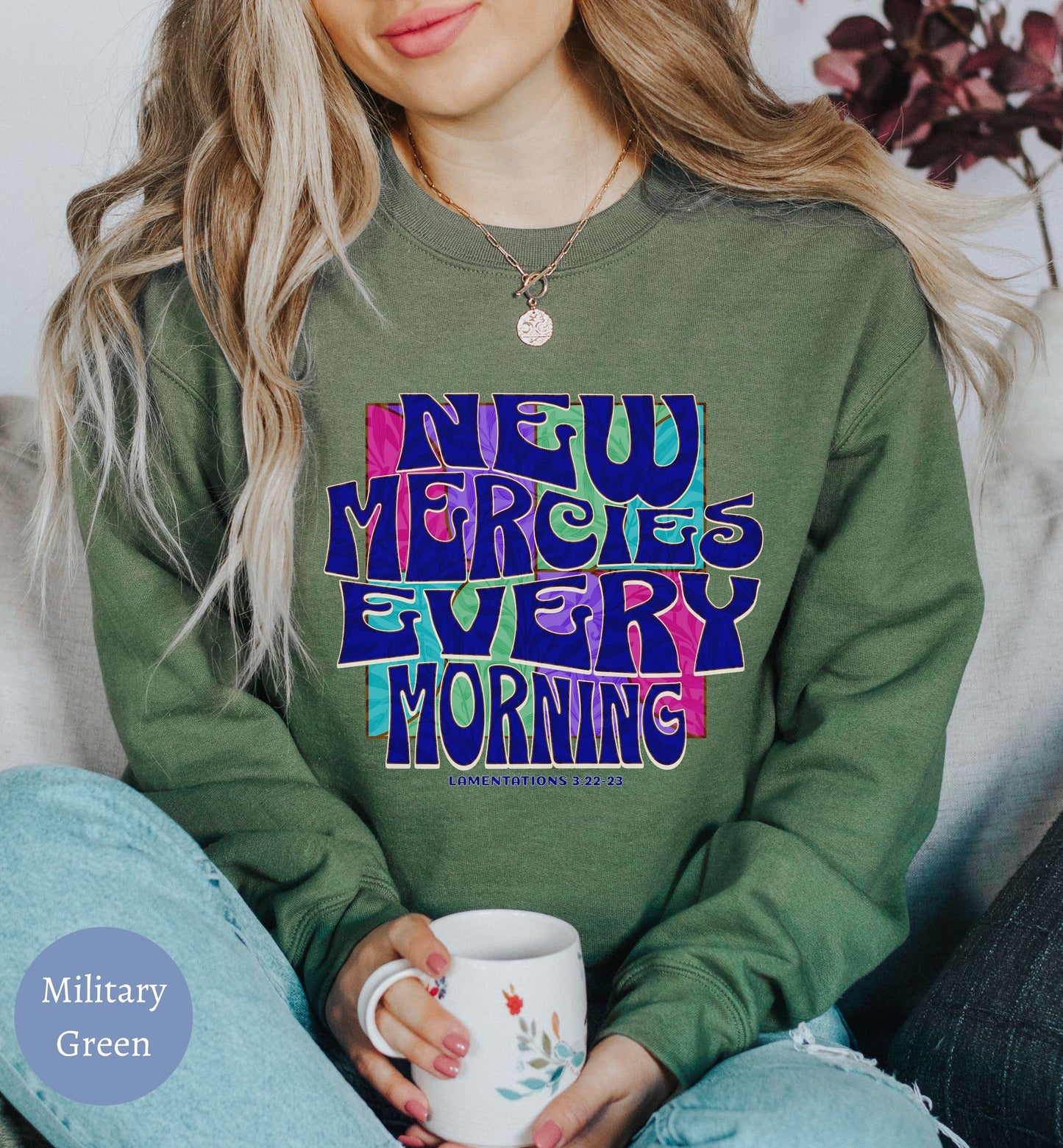 a woman sitting on a couch holding a coffee cup