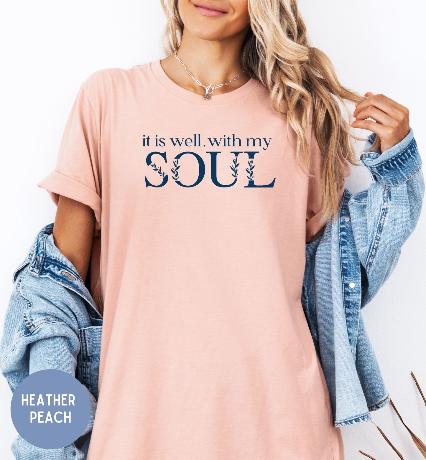 a woman wearing a pink shirt that says it is well with my soul