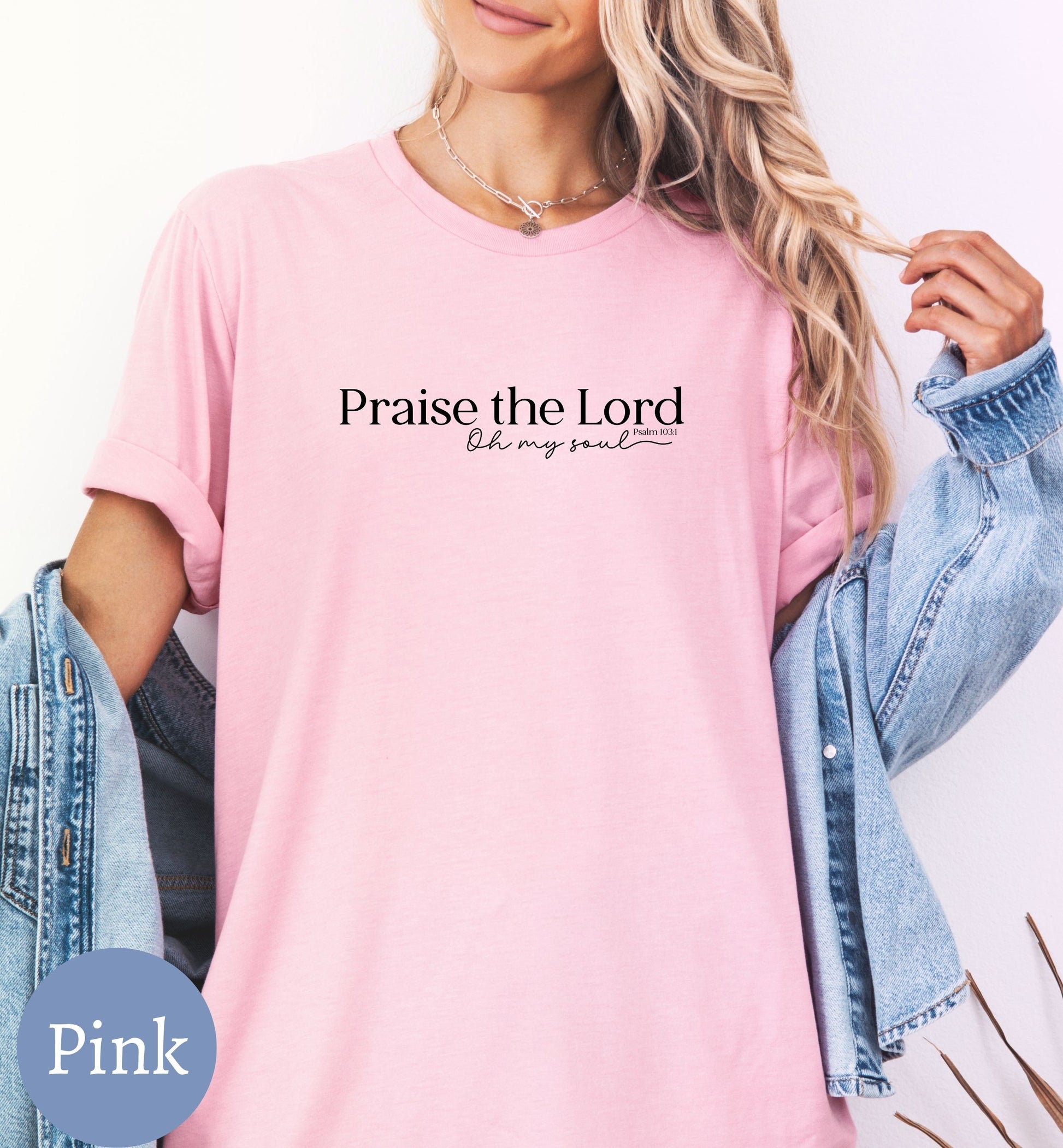 a woman wearing a pink shirt that says praise the lord