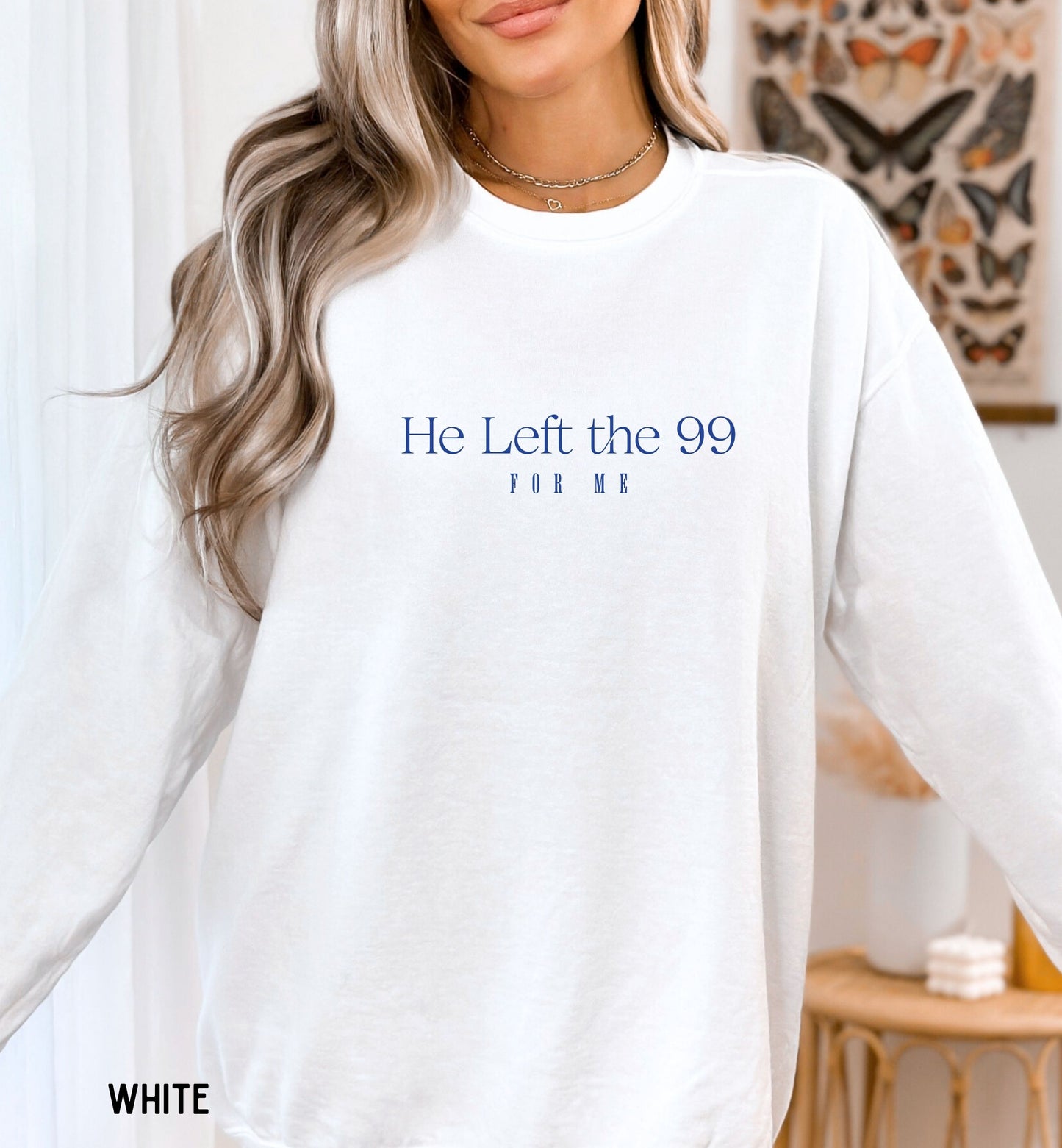 a woman wearing a white shirt that says he left the 99