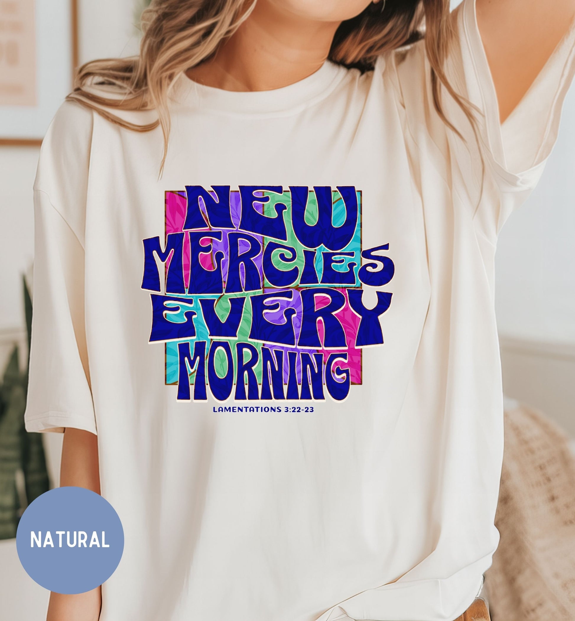 a woman wearing a t - shirt that says new mercies every morning