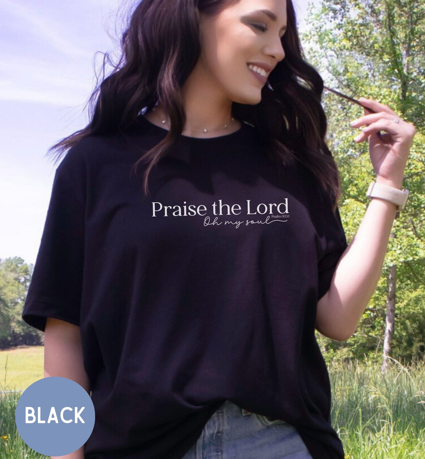 a woman wearing a black shirt with the words praise the lord on it