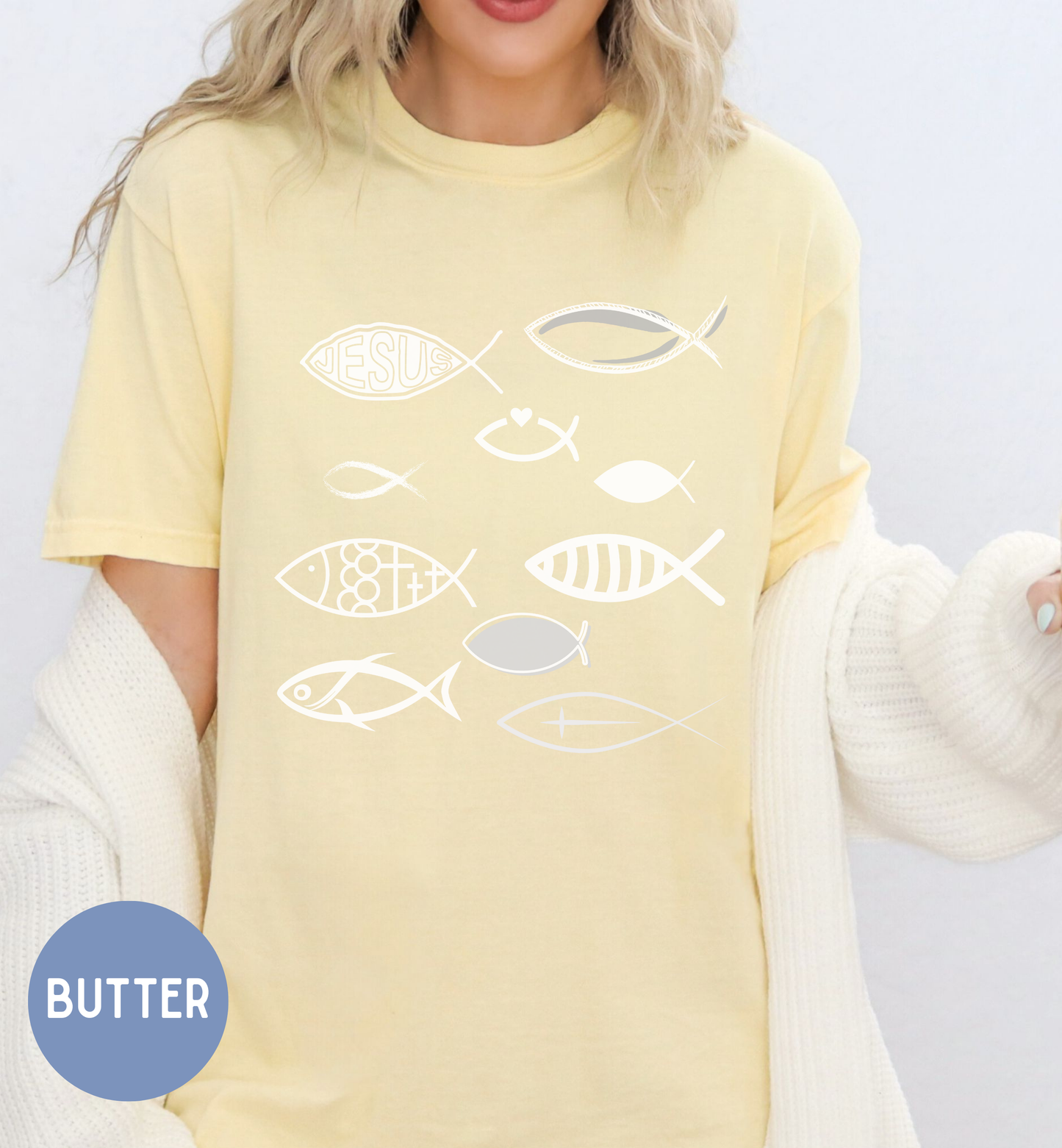 a woman wearing a yellow shirt with fish on it