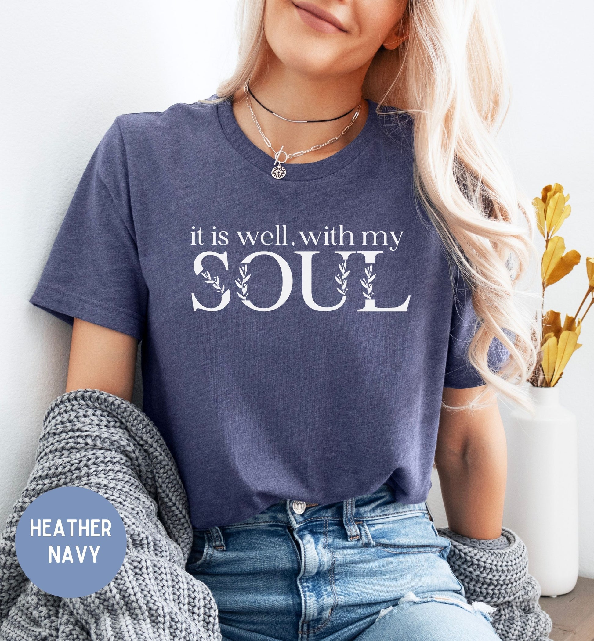 a woman wearing a t - shirt that says it is well with my soul