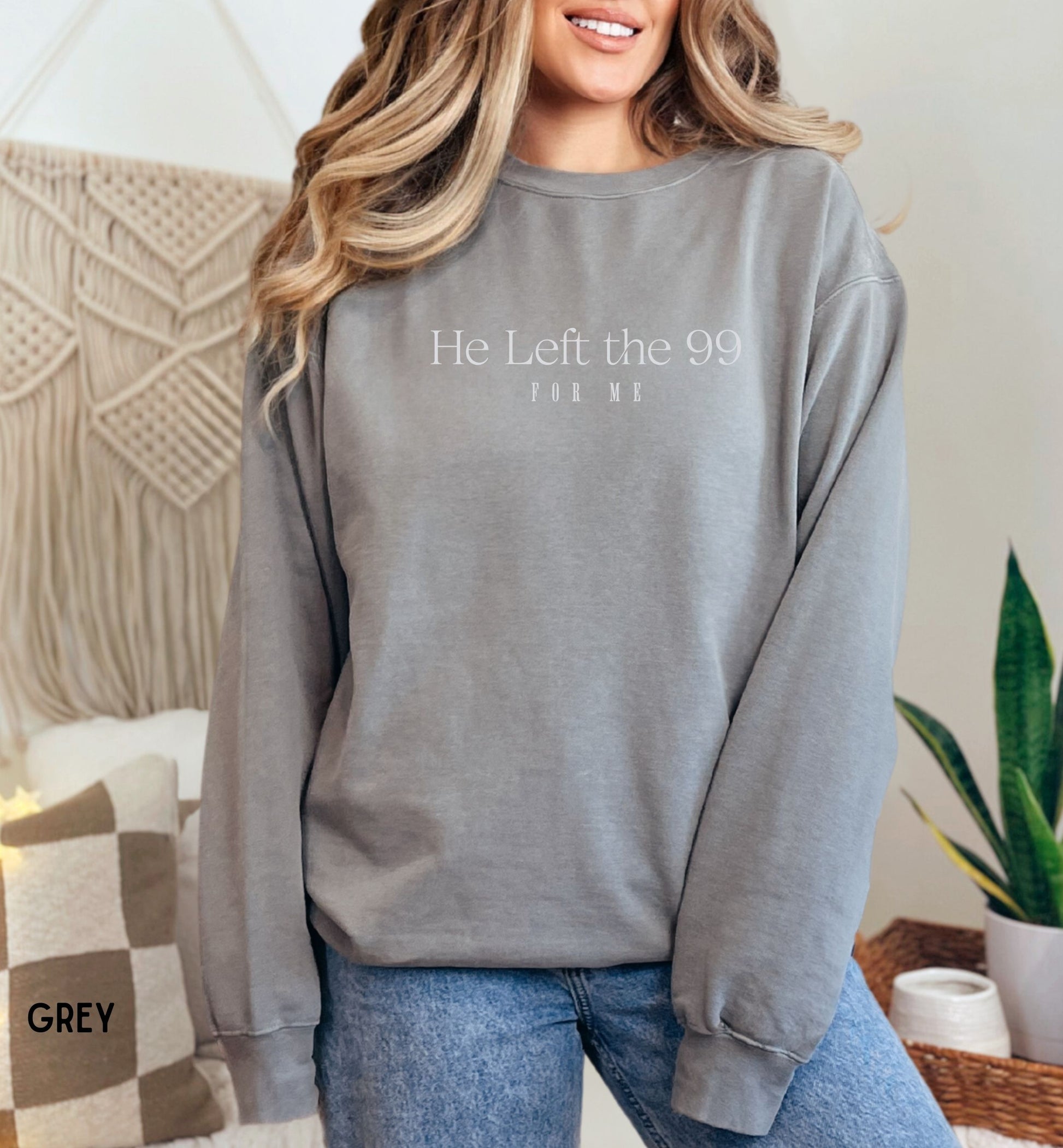 a woman wearing a grey sweatshirt that says he left the 99