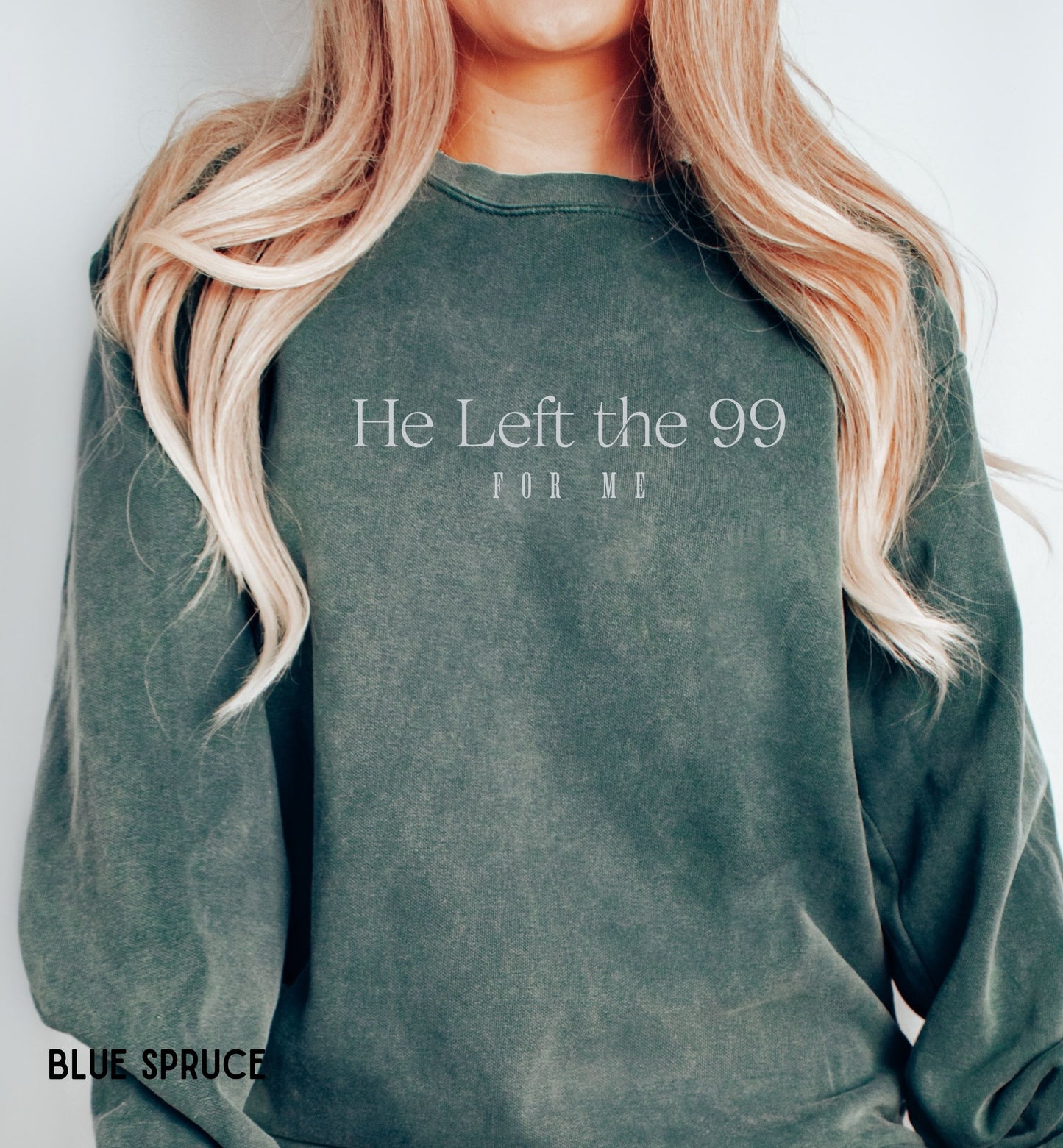 a woman with blonde hair wearing a green sweatshirt