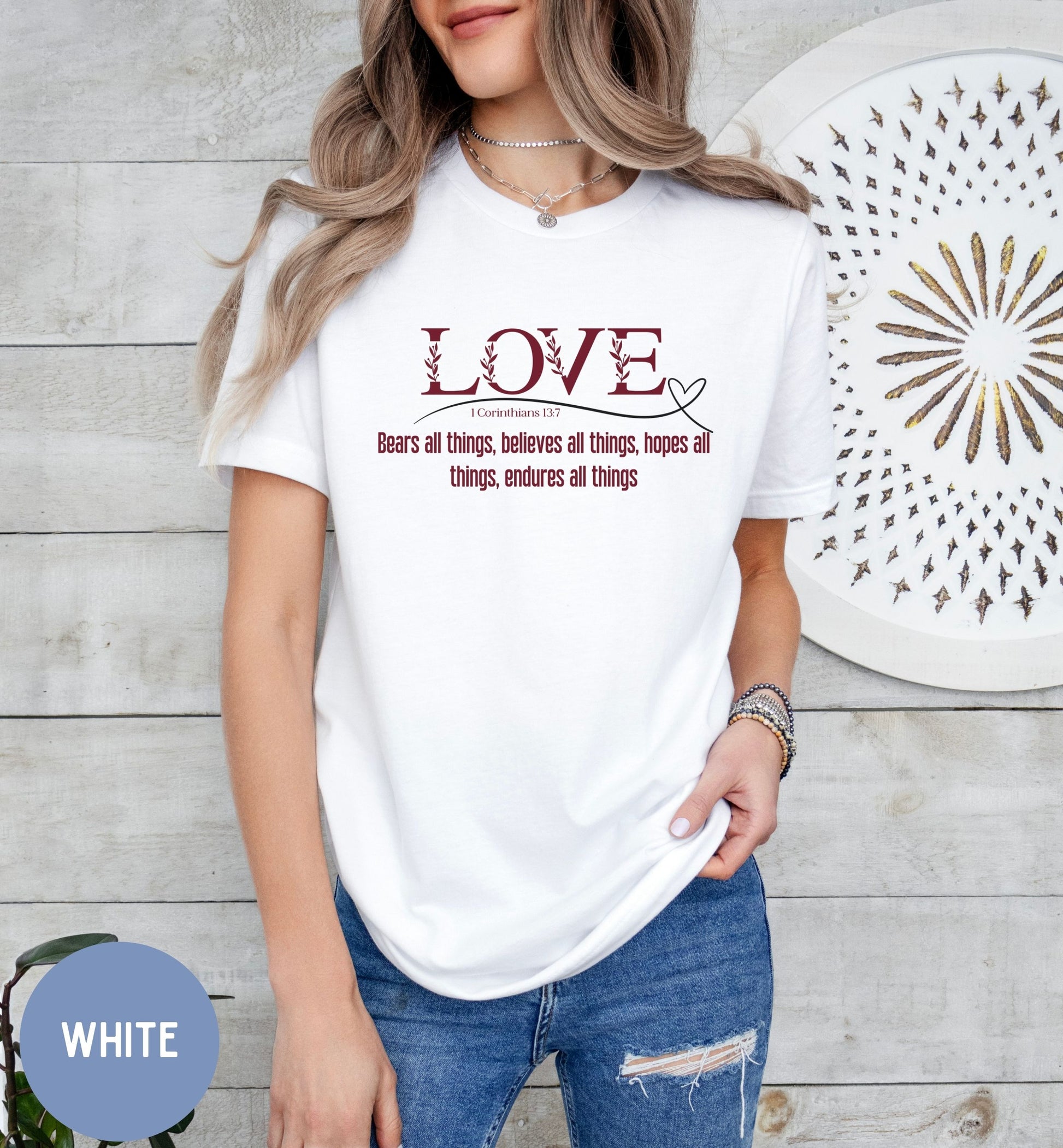 a woman wearing a white t - shirt with the words love on it