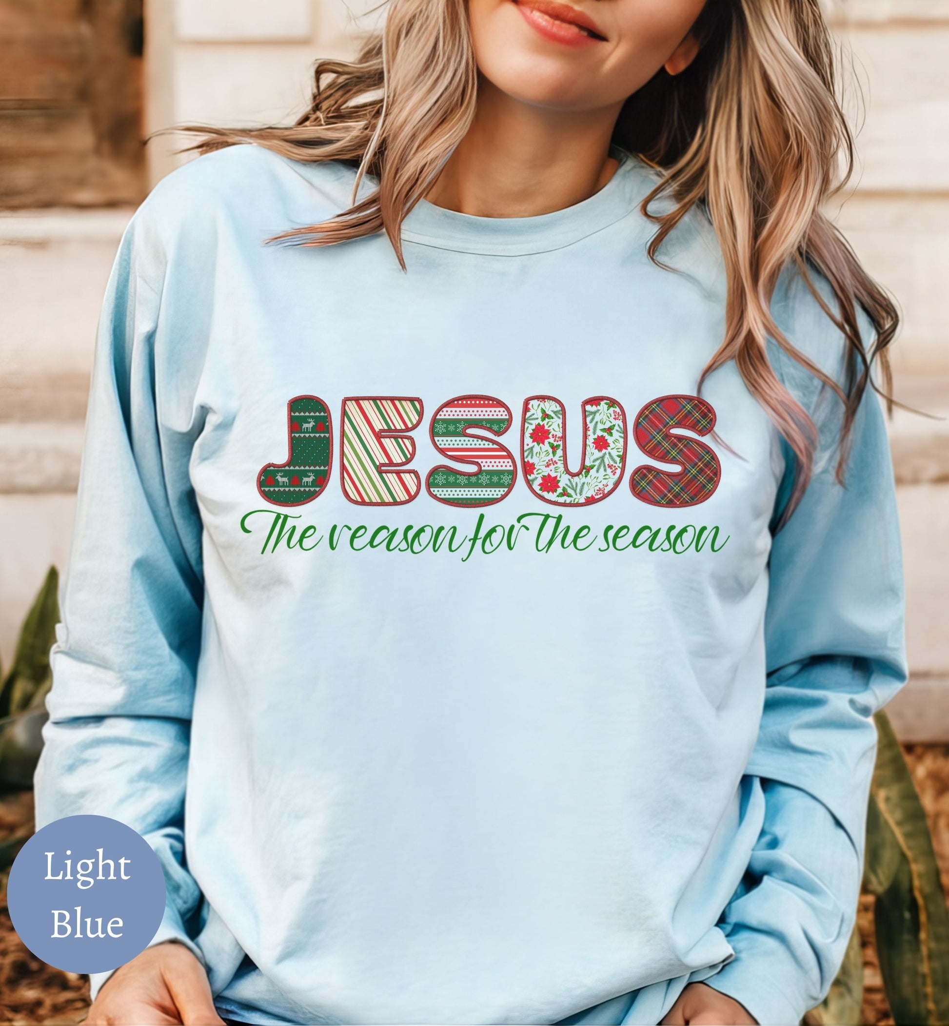 a woman wearing a light blue jesus the reason of the season sweatshirt