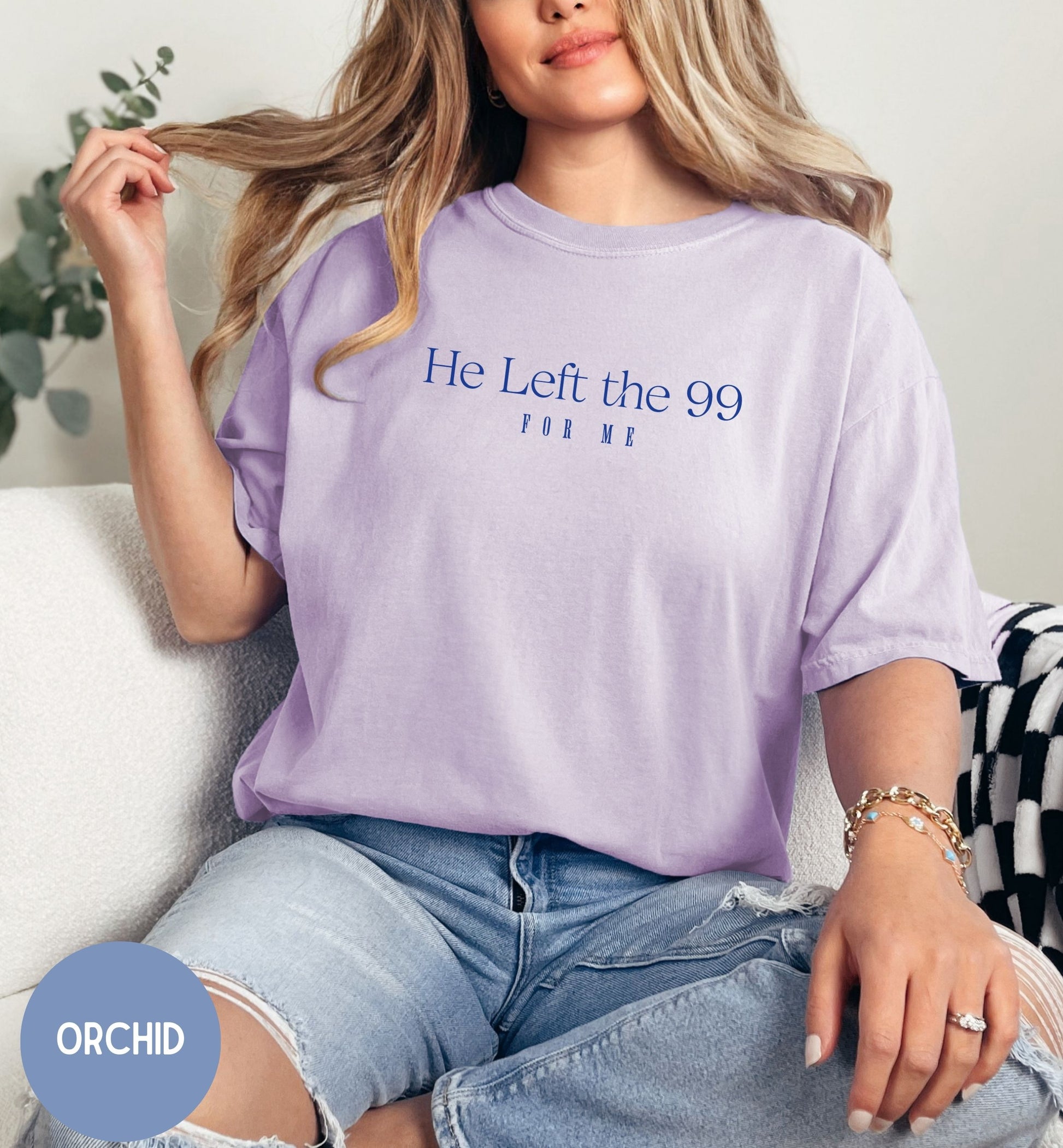 a woman sitting on a couch wearing a t - shirt that says he left the